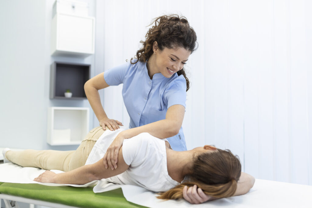 Chiropractor performing a hands-on spinal adjustment on a patient