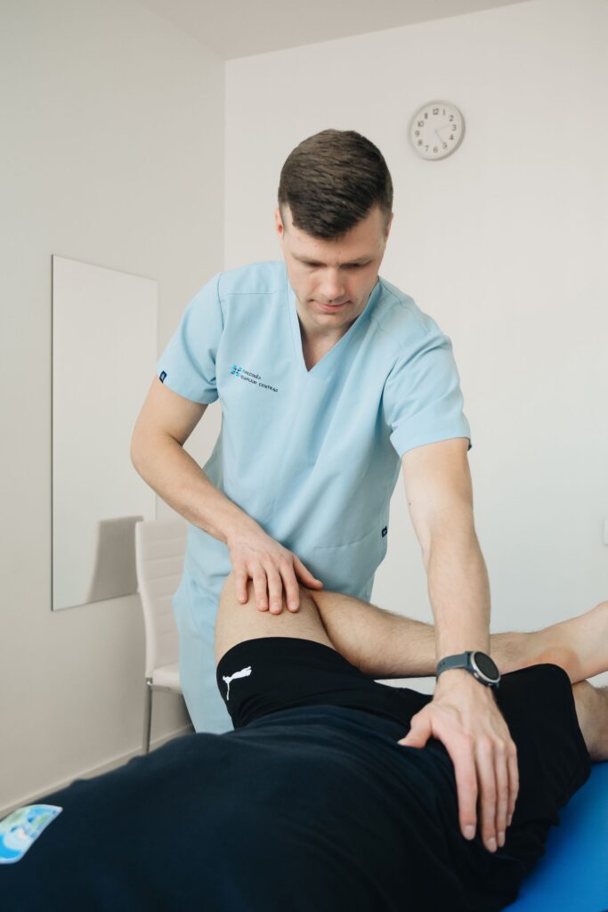 Therapist performing Active Release Technique on a patient's leg
