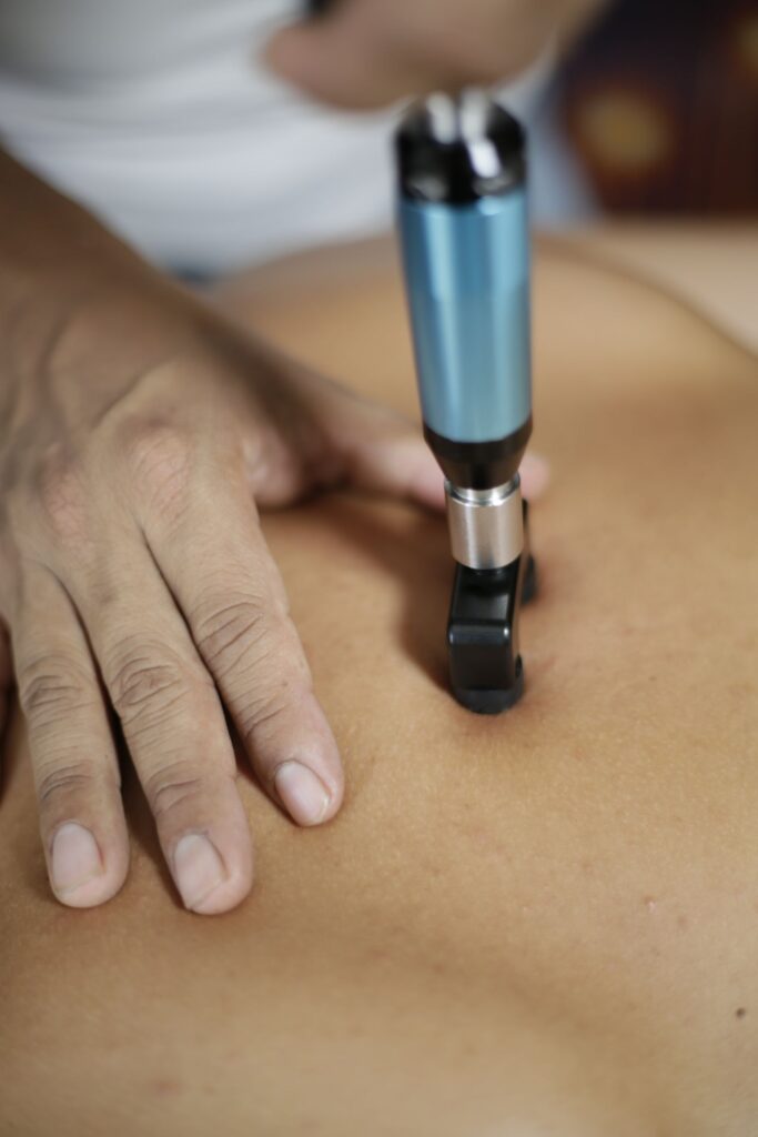 Chiropractic adjusting instrument used on a patient spine