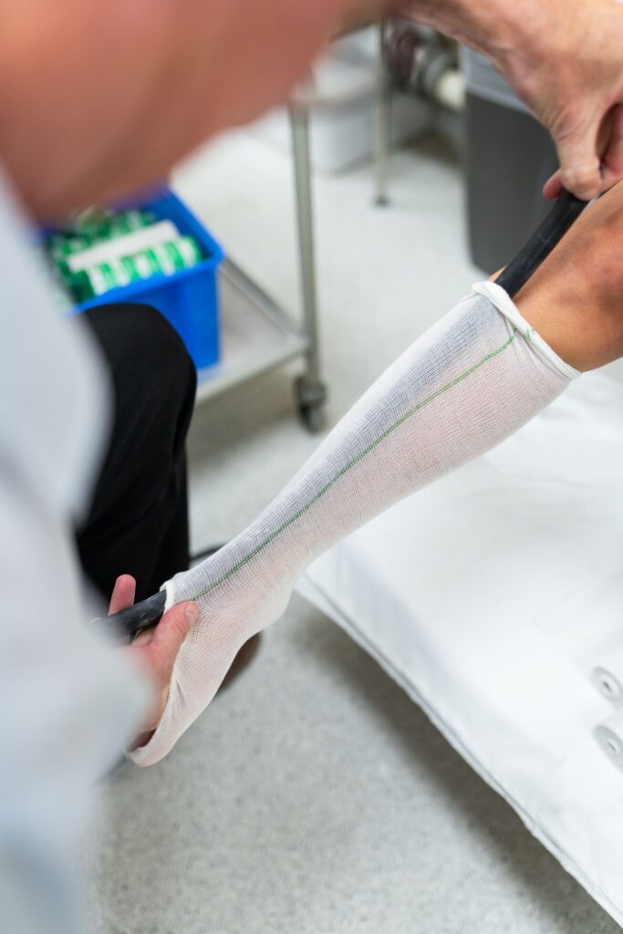 Clinician measuring a patient leg and foot for orthotics