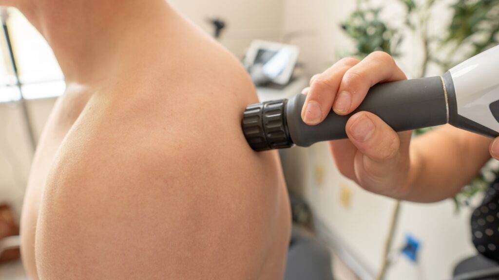 Shockwave pressure wave therapy applied to a patient shoulder